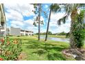 Scenic view of the backyard overlooking a tranquil pond and lush green landscape at 7173 W Country Club N Dr # 141, Sarasota, FL 34243