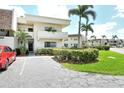 Beautiful condo with neatly kept landscaping, palm trees, and convenient parking at 7173 W Country Club N Dr # 141, Sarasota, FL 34243