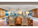Bright living room with ocean views, shuttered windows, and a work space at 8592 Hidden Lagoon Rd, Sarasota, FL 34242