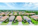 An aerial view showcases residences with manicured lawns in a beautiful neighborhood at 8721 Trattoria Ter, Sarasota, FL 34238