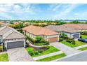 Charming single-story home featuring a tile roof, landscaped front yard, and a two-car garage at 8721 Trattoria Ter, Sarasota, FL 34238
