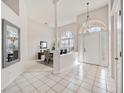 Bright foyer with tile flooring, high ceilings, an arched window, and an adjacent dining area at 8824 Havenridge Dr, Sarasota, FL 34238