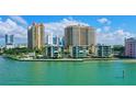 Beautiful waterfront condos with lush landscaping and serene water views create a relaxing atmosphere at 99 Sunset Dr # 102, Sarasota, FL 34236