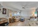 Comfortable living room with large windows, blinds, and stylish furnishings at 1110 49Th Avenue W Dr, Bradenton, FL 34207
