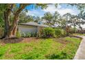 A beautifully landscaped yard surrounds this home, accented by stone and mulch beds at 11219 93Rd St, Largo, FL 33773