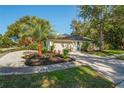 Well-maintained home featuring a two-car garage, lush landscaping, and a pristine driveway at 11219 93Rd St, Largo, FL 33773