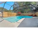 A sparkling in-ground pool is screened in with a seating area, making it perfect for outdoor relaxation at 11219 93Rd St, Largo, FL 33773