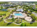 Aerial view of community amenities featuring a pool, playground, basketball court, and surrounding neighborhood at 12592 Ryegrass Loop, Parrish, FL 34219