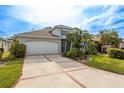 Well-maintained two-story home with a wide driveway and lush landscaping at 1322 Millbrook Cir, Bradenton, FL 34212