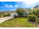 Lovely single-Gathering home featuring a pristine lawn and mature landscaping at 1322 Millbrook Cir, Bradenton, FL 34212