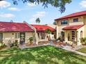 Beautiful condo with a red tiled roof, lush green lawn, and inviting walkways at 1421 57Th W St # 1421, Bradenton, FL 34209