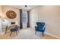 Bright bedroom featuring a brick accent wall, study area, and two comfortable chairs at 17037 James Trl, Parrish, FL 34219