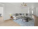 Bright living room with a comfortable sectional sofa, stylish round coffee table, and contemporary decor at 17549 Timberline Pkwy, Punta Gorda, FL 33982