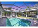 Screened outdoor pool area features patio, an outdoor bar, and green space at 1815 Grove St, Sarasota, FL 34239