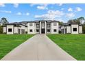 Modern home with a long driveway and a well-maintained lawn at 20307 74Th E Ave, Bradenton, FL 34202
