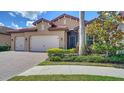 Beautiful home exterior with manicured landscaping and brick-paved driveway leading to a two-car garage at 227 Maraviya Blvd, Nokomis, FL 34275