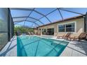 Relaxing screened-in pool area with comfortable lounge chairs on the pool deck at 227 Maraviya Blvd, Nokomis, FL 34275
