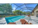 Beautiful screened-in pool with lush landscaping offering a private backyard retreat at 227 Maraviya Blvd, Nokomis, FL 34275