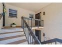 Inviting entryway with stairs leading to the unit's front door, plus decorative lighting and neutral decor at 2640 Clubhouse Dr # 204, Sarasota, FL 34232