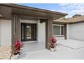 Inviting front porch with modern design elements and decorative potted plants at 2881 48Th E Way, Bradenton, FL 34203