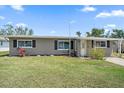 Inviting single-story home with a green lawn, and welcoming curb appeal at 3041 Teal Ave, Sarasota, FL 34232