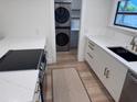Updated kitchen featuring white cabinets, granite countertops, and stainless steel appliances at 3312 Bay Shore Rd, Sarasota, FL 34234