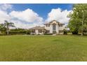 Beautiful home with a large manicured lawn, complemented by tasteful landscaping and mature trees at 3607 Twin Rivers Trl, Parrish, FL 34219