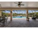 Relaxing outdoor screened patio with a lovely pool featuring an elegant tile waterfall design at 3607 Twin Rivers Trl, Parrish, FL 34219