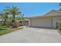 Attractive home exterior showcasing a neutral color palette, lush landscaping, and a spacious driveway at 3890 Wilshire Cir # 27, Sarasota, FL 34238