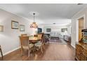 Cozy living area featuring hardwood floors, a stained glass light fixture, and comfortable seating at 3890 Wilshire Cir # 27, Sarasota, FL 34238