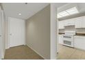 Hallway with tile floors, a front door, and a kitchen with white appliances at 3950 Ironwood Cir # 206, Bradenton, FL 34209