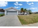 Well-maintained home featuring a two-car garage, landscaped front yard, and a spacious driveway at 4033 Dover E Dr, Bradenton, FL 34203