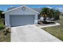 Well-maintained home featuring a two-car garage, landscaped front yard, and a spacious driveway at 4033 Dover E Dr, Bradenton, FL 34203