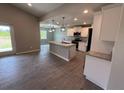 Modern kitchen boasts white cabinets, granite countertops, and stainless steel appliances at 5082 Rilke Ln, Port Charlotte, FL 33981