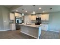 Well-equipped kitchen with a center island, stainless appliances, and ample storage at 5082 Rilke Ln, Port Charlotte, FL 33981