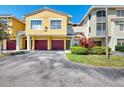 Bright two-story townhome with individual garages, well-maintained landscaping, and an inviting entrance at 5601 Bentgrass Dr # 10-105, Sarasota, FL 34235