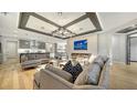 Modern living room featuring hardwood floors, recessed lighting, modern fireplace, and stylish furniture at 5793 Long Shore Loop, Sarasota, FL 34238