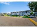 Exterior shot of light blue condos with manicured lawns, white stairways and assigned parking at 6033 34Th W St # 132, Bradenton, FL 34210