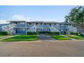 Well-maintained condo complex with assigned parking spaces, green lawns, and landscaped bushes at 6033 34Th W St # 132, Bradenton, FL 34210