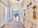 Elegant foyer featuring tile flooring, a decorative rug, and a view of the living area through an arched doorway at 6729 45Th E Ter, Bradenton, FL 34203