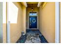 Inviting entryway with a decorative wreath on the front door and textured yellow walls at 6729 45Th E Ter, Bradenton, FL 34203