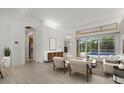 Bright living room with stylish furniture, wood flooring, and sliding doors to the outdoor pool area at 7602 Partridge Street Cir, Bradenton, FL 34202