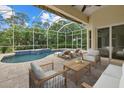 Relaxing screened patio with a beautiful pool, comfortable lounge chairs, and a ceiling fan at 7602 Partridge Street Cir, Bradenton, FL 34202