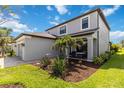 Beautiful home exterior with lush landscaping, gray paint, and a cozy front porch at 9061 Luna Ln, Sarasota, FL 34241