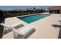 Outdoor swimming pool with clear water and lounge chairs for relaxation, surrounded by a concrete deck at 3724 71St E Ter, Sarasota, FL 34243