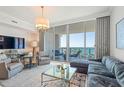 Stylish living room with elegant furnishings, a plush sofa, and floor-to-ceiling windows showcasing picturesque water views at 1155 N Gulfstream Ave # 706, Sarasota, FL 34236
