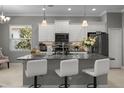 This modern kitchen features granite countertops, sleek white cabinetry, and stainless steel appliances at 11707 Gramercy Park Ave, Bradenton, FL 34211