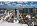 Stunning aerial view of a beachfront condo with a pool, tennis court and panoramic ocean views at 1212 Benjamin Franklin Dr # 901, Sarasota, FL 34236