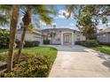 Inviting single-story home with well-maintained lawn, mature palm trees, and spacious driveway at 1217 92Nd Nw St, Bradenton, FL 34209