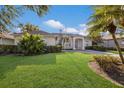 Beautiful single-story home with lush green lawn, well-manicured bushes, and neutral color palette at 1217 92Nd Nw St, Bradenton, FL 34209